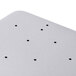 A white coated tray liner with black dots on a metal surface.