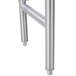 The metal legs of an Advance Tabco filler table.