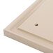 A beige polyethylene carving board with holes in it.
