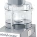 A clear Robot Coupe cutter bowl on a food processor.
