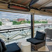 A Bromic Heating black Tungsten Smart-Heat electric outdoor patio heater on a balcony with a view of the city.