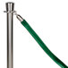 A silver pole with a green velvet rope and satin ends.