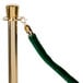 A green velvet rope with brass ends.