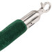 A green velvet handle with silver hooks on the end of a green rope.