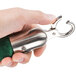 A person holding a green and silver Aarco crowd control rope with satin ends.