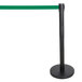 A black pole with a green retractable belt.