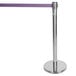 A silver metal Aarco crowd control stanchion with a purple retractable belt.