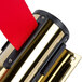 A gold wall-mount stanchion with a red tape.