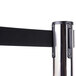 A chrome and black Aarco crowd control stanchion pole with black and silver retractable belt.