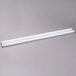 Two white fluorescent tubes on a gray surface.