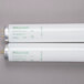 A close-up of two white Curtron T5 fluorescent tubes.