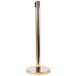 A gold metal Aarco crowd control stanchion pole.