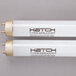 A close-up of a white box with two Curtron T8 fluorescent tubes inside.
