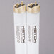 Two white Curtron UV tubes with gold caps.