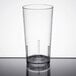 A clear Cambro plastic tumbler on a table.