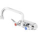 A T&S chrome wall mount faucet with blue and red handles.