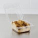A Dart clear hinged plastic container with a piece of cake in it.