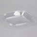 A clear plastic square lid for Dart square plastic bowls.