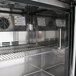 A Turbo Air stainless steel undercounter freezer with shelves.