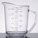 A clear Cambro measuring cup with red and blue measurement lines.
