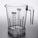 A clear plastic Waring blender container with a handle and measuring cup on top.