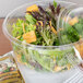 A salad in a Dart clear plastic container.