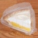 A Dart Clearseal clear hinged plastic container with a slice of pie inside.