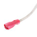 A close-up of a white cable with a pink connector.