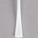A white plastic tasting fork with a black handle.