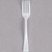A Fineline Tiny Tines white plastic tasting fork.