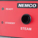 A red Nemco box with a black knob and dial.