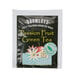 A black and green Bromley Exotic Passion Fruit Green Tea packet with yellow text.