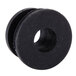 A close-up of a black rubber plug with a hole in it.