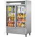 A Turbo Air Super Deluxe reach-in refrigerator with a glass door full of food.