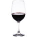 A Thunder Group reusable plastic wine glass filled with red wine.