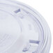 A close-up of a clear plastic lid with a caution label on a white box.