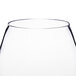 A close up of a clear Thunder Group plastic wine glass.