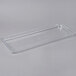 A clear plastic rectangular lid on a clear plastic tray.