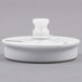 A white plastic Cecilware Gentle Agitation Impeller with a round top and hole in the center.