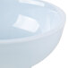 A light blue Thunder Group melamine bowl with a white rim.