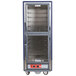 A large blue Metro C5 hot holding cabinet with clear Dutch doors and wire shelves.