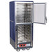 A blue and silver metal cabinet with clear doors holding food.
