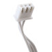 A close-up of a white cable with a white connector on it.