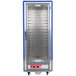 A blue Metro C5 hot holding cabinet with clear doors and shelves on wheels.