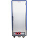 A large silver and blue Metro C5 hot holding cabinet with a blue and silver solid door.