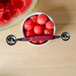 A bowl of watermelon balls with a Thunder Group Double Melon Baller on a counter.