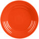 A close up of a Fiesta® Poppy luncheon plate with a circular pattern on the rim.