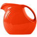 A Fiesta® large disc pitcher in poppy with a red handle.