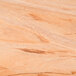 A close up of the wood surface of an American Metalcraft olive wood serving board.