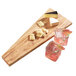 An American Metalcraft olive wood serving board with a variety of snacks on it.